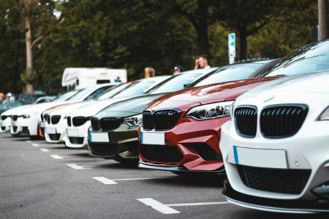 A row of parked used cars in a lot